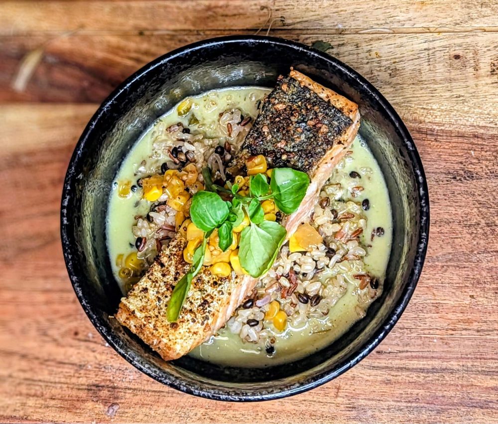 Herb-crusted salmon over wild rice plated by Chef Brian Schultze, private chef.